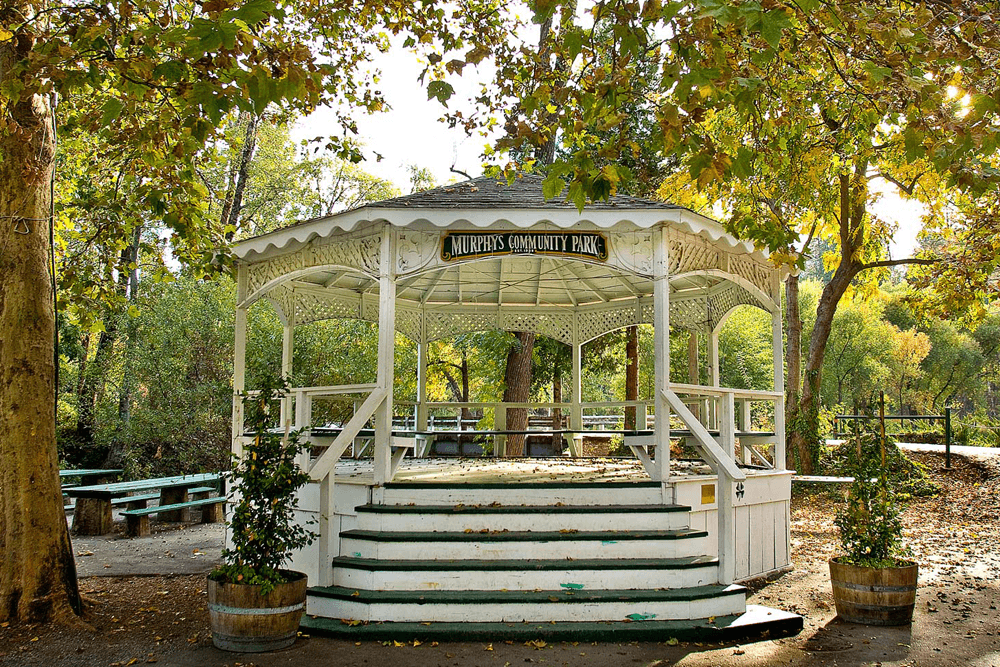 A white gazebo in Murphys Community Park surrounded by trees.